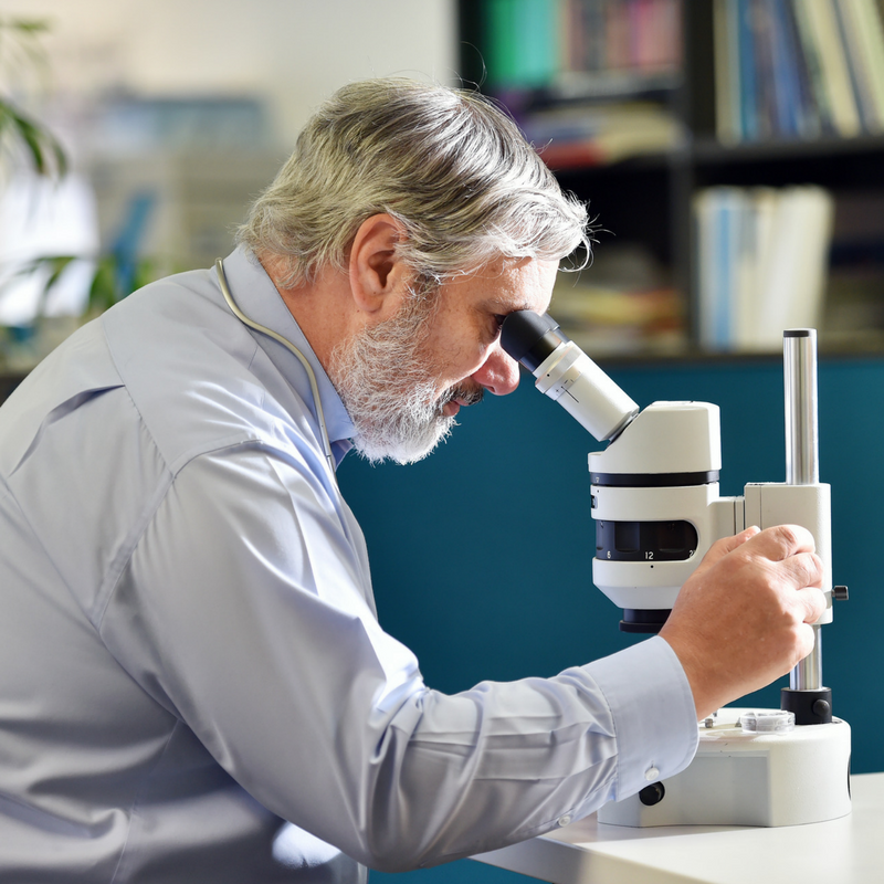 Doctor Researching with Microscope