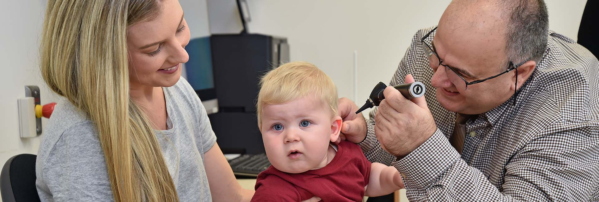 Doctor performing audiology tests